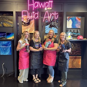 Four women in aprons holding art cups at Hawaii Fluid Art.