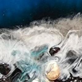 Abstract resin art of ocean waves with rocky shoreline.